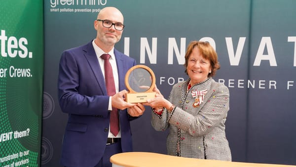 Two people with award