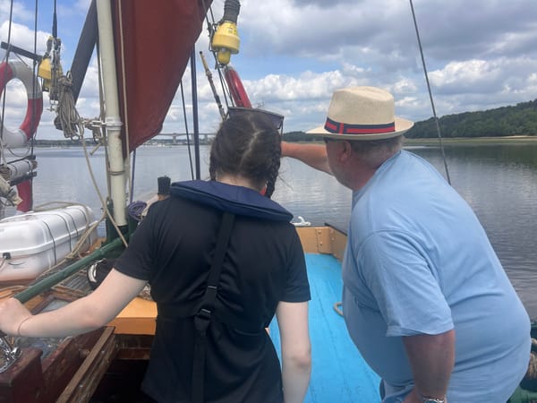 A young person on the water looking out to the Orwell Bridge