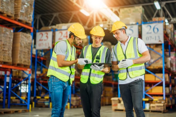 Logistics warehouse three men