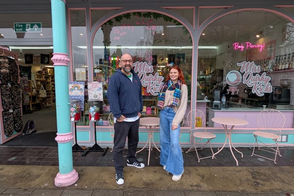 Two people stood outside shop